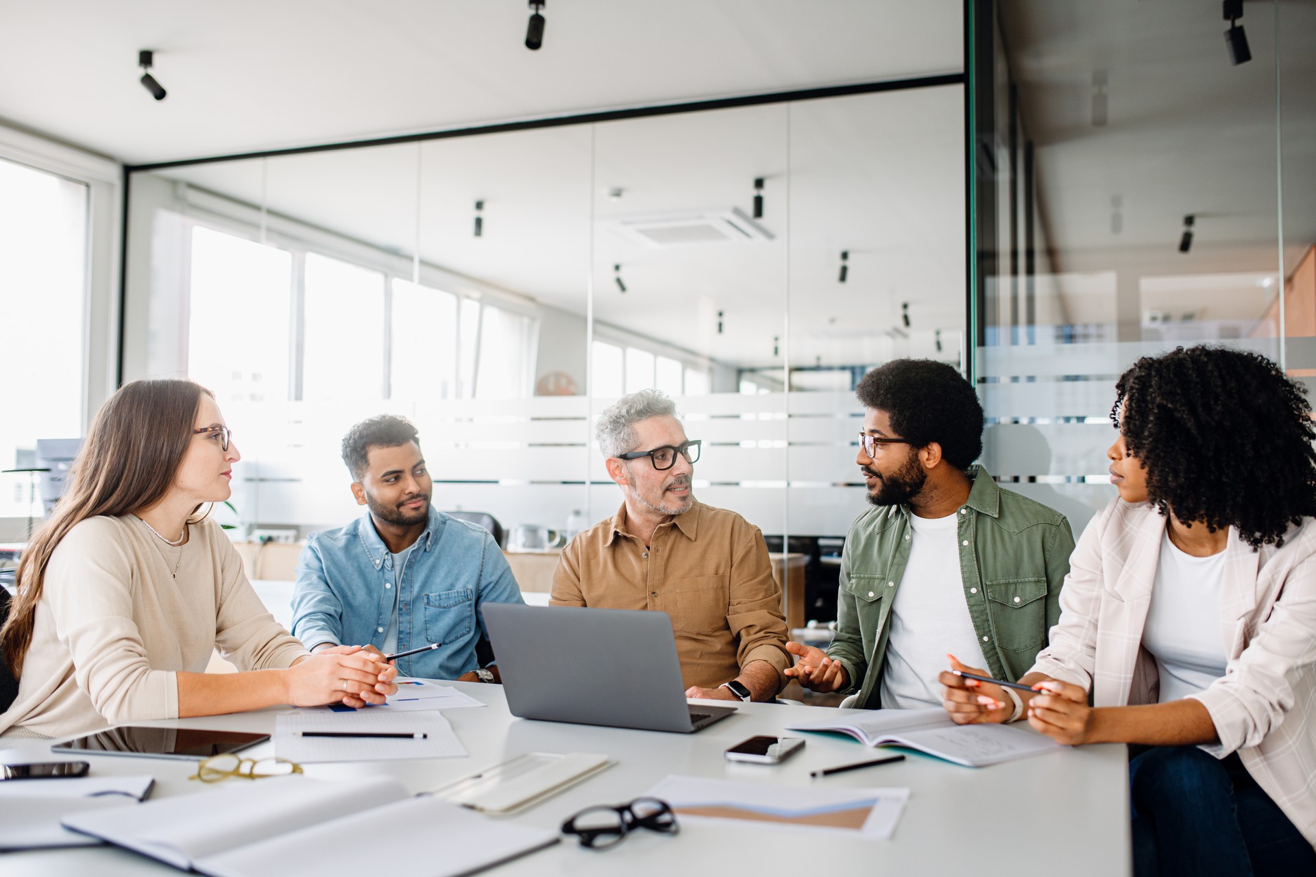 Colleagues engage in a lively exchange of ideas in an office